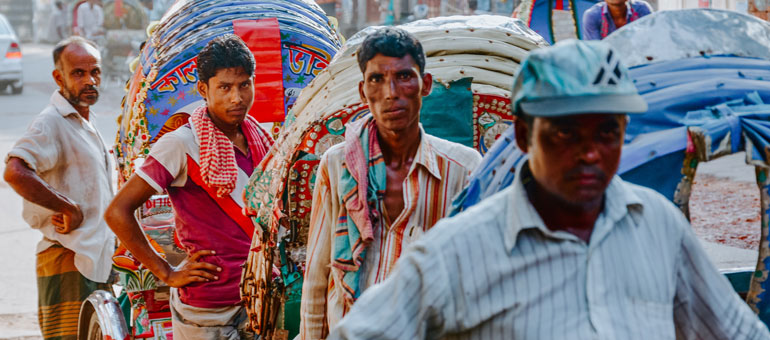 A group of hardworking trishaw operators waiting for customers in Dhaka, Bangladesh.