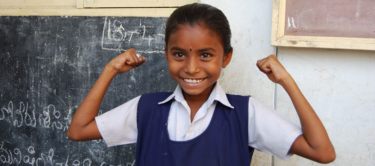 Little Indian girl raises her arms in show of strength 
