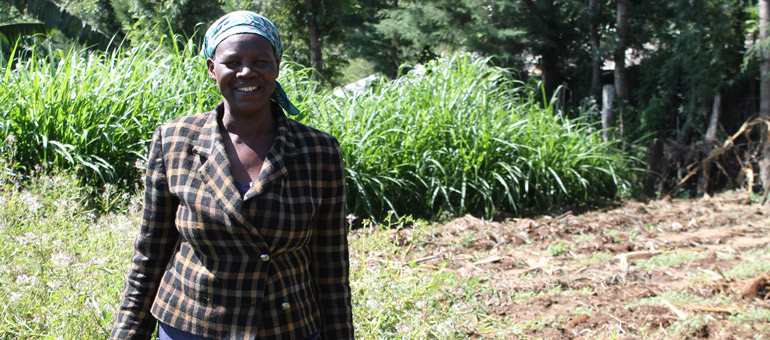 Tea worker standing in the field and smiling