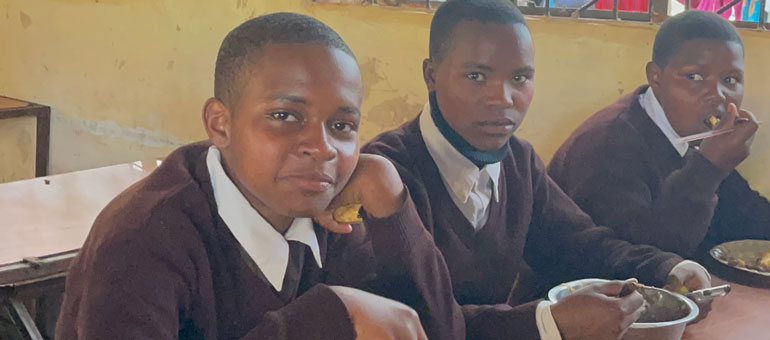 kids in Tanzania eating at school