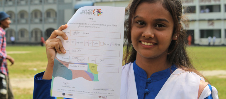 girl holding a pledge