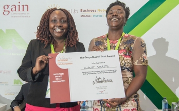 Woman receives a prize for her work in nutrition at the Nutrition Africa Investor Forum (NAIF)