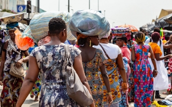 Two women walking in a market in Africa
