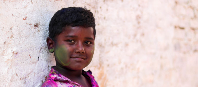 Boy in pakistan wearing colordul shirt and smiling