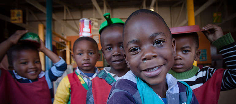 Kindergarten kids playing with kitchen tools in Africa 