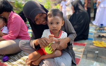 Mother holding her baby and smiling