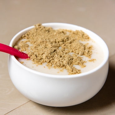 Porridge in a cup with red spoon